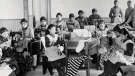 This file photo shows students at a residential school being taught how to sew.