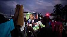 A man, holding up a photo of presidential candidate Leslie Voltaire, demonstrates during a campaign rally in Port-au-Prince, Haiti, Monday, Nov. 22, 2010. (AP Photo / Ramon Espinosa)