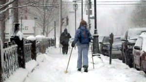 Residents use the snow to their advantage, making their way through town on skis in downtown Fredericton, N.B., in this Sunday, Feb. 17, 2013 file photo.