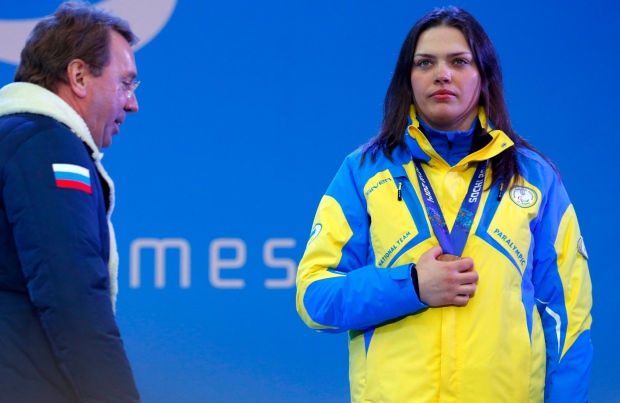 Ukraine athlete covers her medal