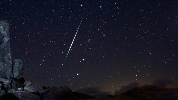 A meteor explodes across night sky