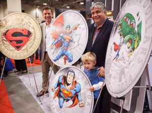 Vice President of Marketing at the Royal Canadian Mint Patrick Hadsipantelis, left, and Leader of the Government in the House of Commons Peter Van Loan and his son John unveil four new collector coins featuring Superman on Friday, August 29, 2014. (Jesse Johnston / THE CANADIAN PRESS)