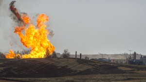 Remaining gas is burned off after explosion and fire at a gas pumping station owned by TransGas near Prud'homme, Sask., Saturday, Oct. 11, 2014. (Liam Richards / THE CANADIAN PRESS)