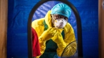 A healthcare worker dons protective gear before entering into an Ebola treatment centre in the west of Freetown, Sierra Leone, Thursday, Oct. 16, 2014. (AP / Michael Duff)