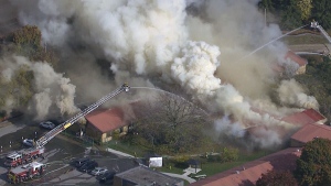 Firefighters battle a blaze at a nursing home in Whitby, Ont., Monday, Oct. 27, 2014.