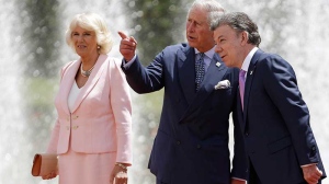 Prince Charles talks to Colombia's President Juan Manuel Santos as his wife Camilla the Duchess of Cornwall stands by during a welcoming ceremony at the presidential palace in Bogota, Colombia, Wednesday, Oct. 29, 2014. (AP / Fernando Vergara)