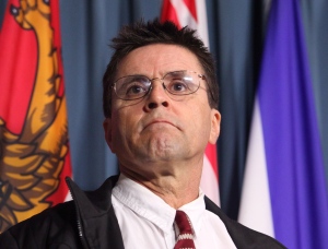 Hassan Diab listens to his lawyer speak at a press conference on Parliament Hill in Ottawa on Friday, April 13, 2012. (Patrick Doyle / THE CANADIAN PRESS)