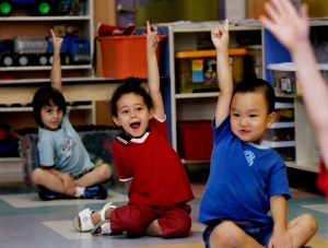 Children put up their hands at a daycare centre in Montreal on Friday, August 18, 2006. (Ian Barrett / THE CANADIAN PRESS)