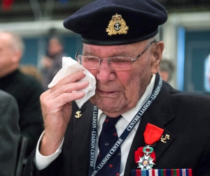 Second World War veteran Allan Bolduc, 91, wipes away a tear after receiving the French Legion of Honour medal at a ceremony at Ste. Anne's Veterans Hospital Thursday, November 20, 2014 in Sainte-Anne-de-Bellevue, Quebec. Seventeen veterans received the medal in recognition of their efforts in the liberation of France during the Second World War. (THE CANADIAN PRESS/Ryan Remiorz)