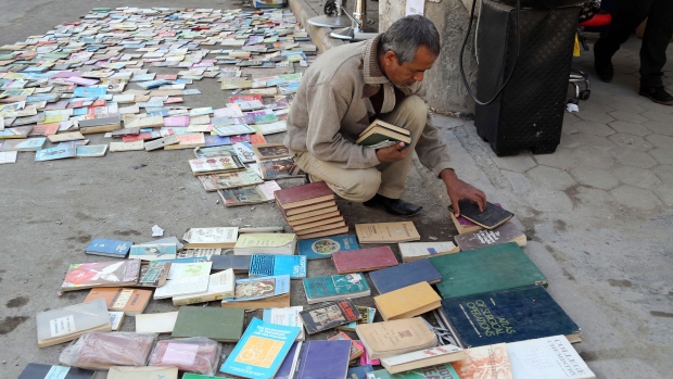Iraqi man looks at books on al-Mutanabi Street