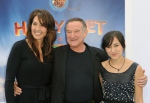 Susan Schneider, Robin Williams, and Zelda Williams arrive at the premiere of 'Happy Feet Two' at Grauman's Chinese Theater, in Los Angeles in 2011. (AP / Katy Winn)