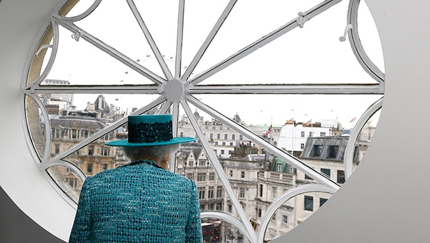 Queen Elizabeth looks at the view out a window