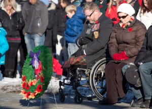 Veteran Paul Franklin, who lost both his legs in a suicide bombing in Kandahar, takes part in a moment of silence during the First Battalion Princess Patricia's Canadian Light Infantry Remembrance Day ceremony in Edmonton, Alberta on Monday November 11, 2013. (THE CANADIAN PRESS / Jason Franson)