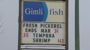 A Gimli Fish Market sign lists fish available in Winnipeg, Man.