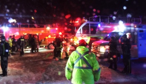 Fire trucks and an airport shuttle are on the scene at the Halifax International Airport early Sunday March 29, 2015 after an Air Canada flight from Toronto made an abrupt landing and left the runway in bad weather. The airline said early Sunday that at least 22 people were taken to a hospital for observation and treatment of minor injuries. (AP / Mike Magnus)