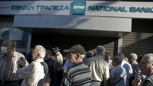 Greek seniors wait outside closed banks