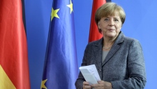 Merkel says EU must share burden of migrant influx
