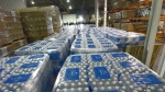 Thousands of bottles of water await distribution in a county warehouse as volunteers accompanied by Michigan State Police and Gennessee County Sheriff's Deputies work their way through Flint neighborhoods, bringing residents water filters and bottled water on Tuesday, Jan. 12, 2016. (Dale G. Young / The Detroit News)