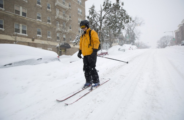Man skiis down street during U.S. snowstorm
