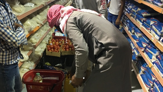 A man carefully selects his groceries.