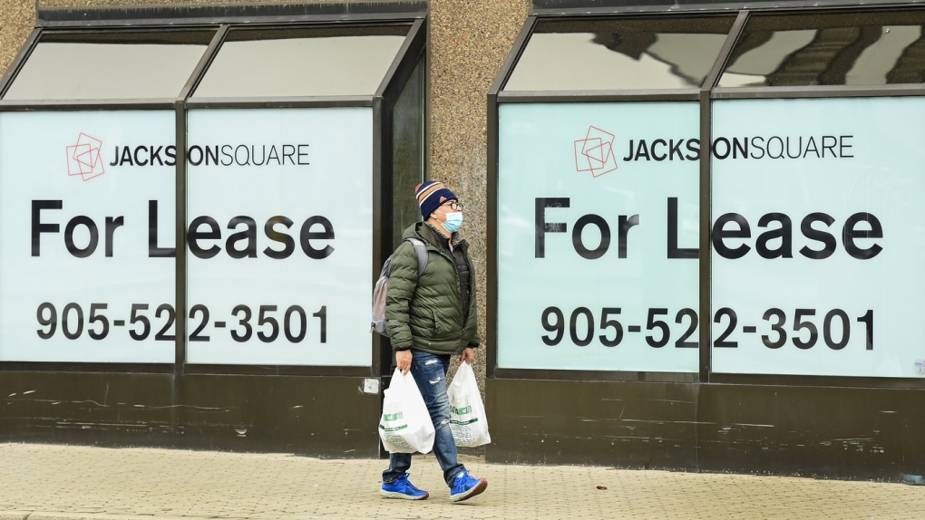 A man walks past office lease signs during the COVID-19 pandemic in downtown Hamilton, Ont., on Thursday, March 18, 2021. THE CANADIAN PRESS/Nathan Denette