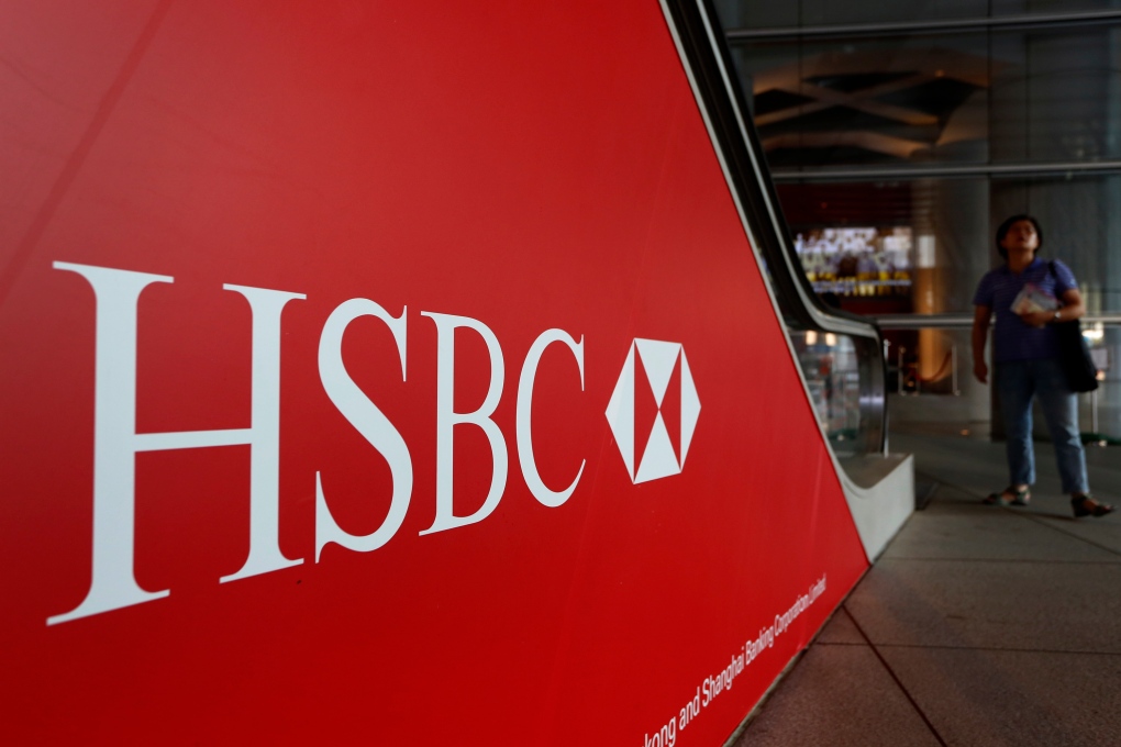 People walk past a logo of the HSBC headquarters in Hong Kong in this July 2012 file photo. (AP Photo/Vincent Yu)