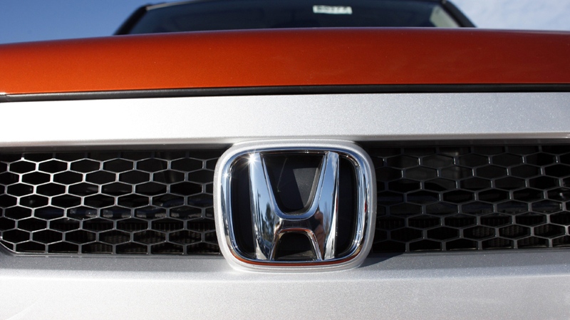 The company logo shines on a new Honda vehicle on Sunday, Nov. 1, 2009.