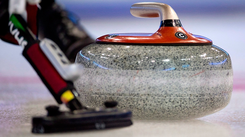 A curling stone is swept down the ice during the afternoon draw at the Tim Hortons Brier in Edmonton, Alta. Thursday, March 7, 2013. (THE CANADIAN PRESS/Jonathan Hayward)