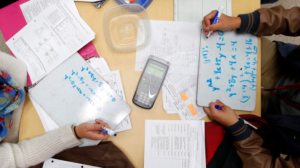 Students solve math problems at a California high school in this January 2013 file photo. (AP / Jae C. Hong)