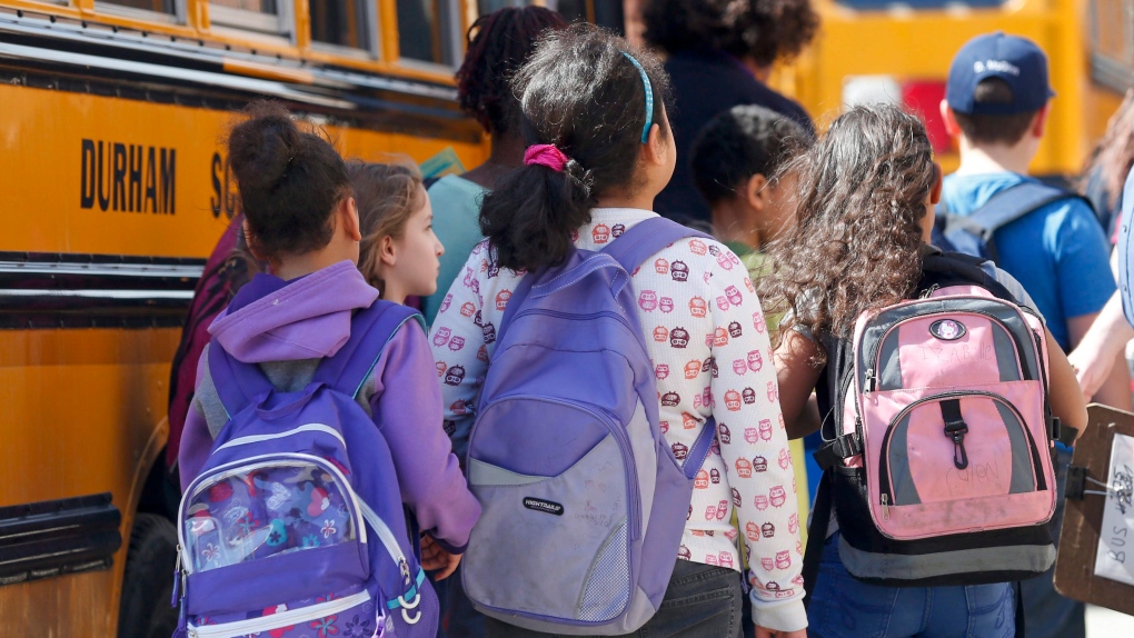 In this file photo, students wait to board a bus after school on Monday, April 13, 2015, in Albany, N.Y. (Mike Groll/AP Photo)