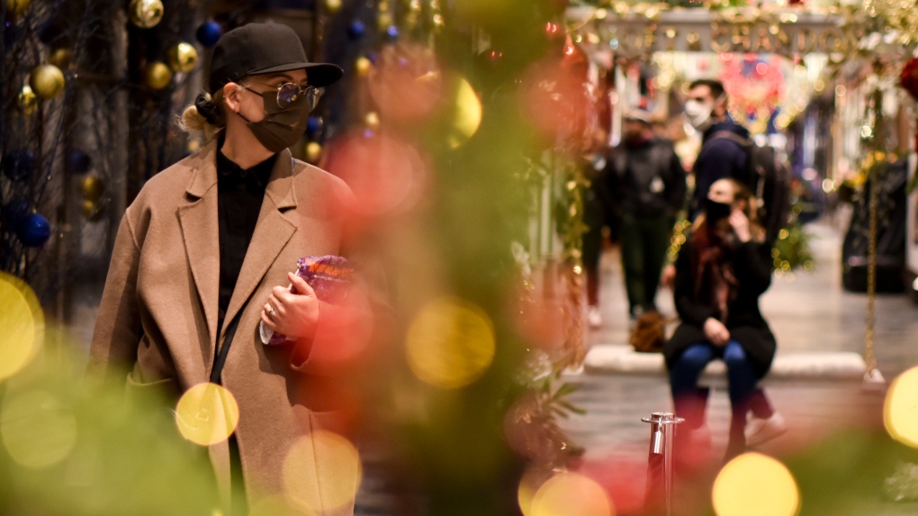 FILE - Shoppers wear a face masks at the Burlington Arcade in London, Tuesday, Dec. 22, 2020. (AP Photo/Alberto Pezzali)