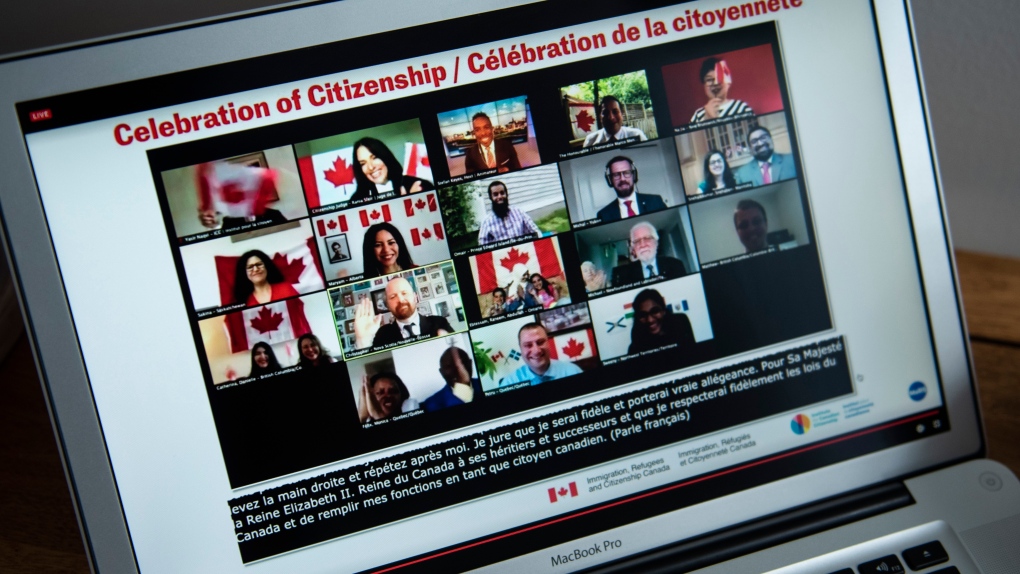 Participants celebrate becoming Canadian citizens after swearing the oath of citizenship during a virtual citizenship ceremony held over livestream due to the COVID-19 pandemic, on Canada Day, Wednesday, July 1, 2020, seen on a computer in Ottawa. (THE CANADIAN PRESS / Justin Tang)