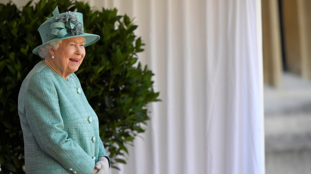 FILE - Queen Elizabeth II looks out during a ceremony to mark her official birthday at Windsor Castle in Windsor, England, Saturday June 13, 2020. (Toby Melville/Pool via AP)