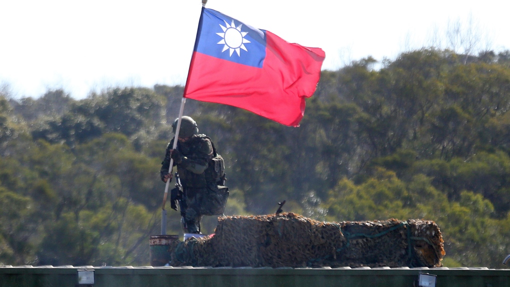 A soldier holds a Taiwan national flag during a military exercise in Hsinchu County, northern Taiwan, Tuesday, Jan. 19, 2021. (Chiang Ying-ying / AP)
