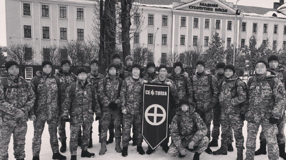 A photo posted in 2019 to Centuria’s Telegram shows a group of uniformed men posing next to one of the buildings of the Ukrainian National Army Academy. The building is part of the NAA’s campus in Lviv. It is possible that Centuria’s manipulation of the original photo included a modification that changed the banner in the resulting image to feature a Sonnenkreuz as opposed to a symbol reminiscent of crosshairs on a target, according to the report. (Oleksiy Kuzmenko/George Washington University IEREs/Military Order Centuria/Telegram)