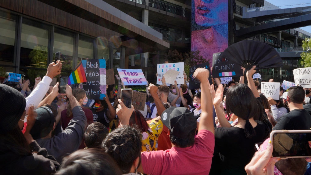 People protest outside the Netflix building on Vine Street in the Hollywood section of Los Angeles, Wednesday, Oct. 20, 2021. Critics and supporters of Dave Chappelle's Netflix special and its anti-transgender comments gathered outside the company's offices Wednesday, with "Trans Lives Matter" and "Free Speech is a Right" among their competing messages. (AP Photo/Damian Dovarganes) 