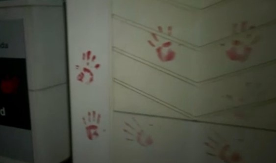 Red hand prints placed on Environment Canada building during climate rally, 3 people arrested