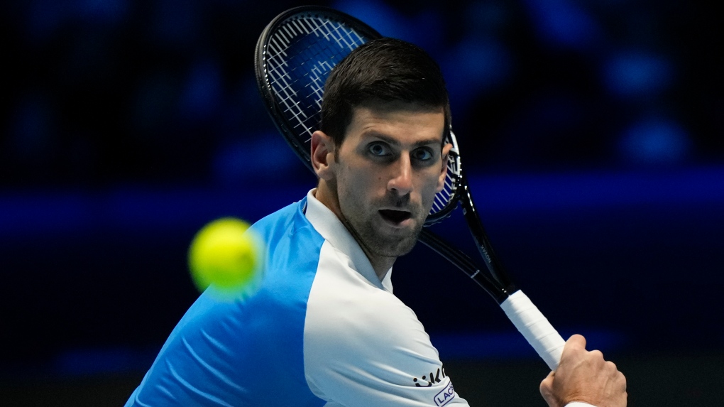 Novak Djokovic returns the ball to Cameron Norrie during their ATP World Tour Finals singles tennis match, at the Pala Alpitour in Turin, Friday, Nov. 19, 2021. (AP Photo/Luca Bruno) 