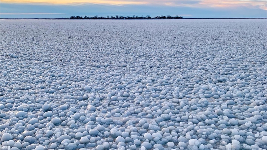 'I have never seen anything like it': Strange weather phenomenon leaves Lake Manitoba covered in ice balls