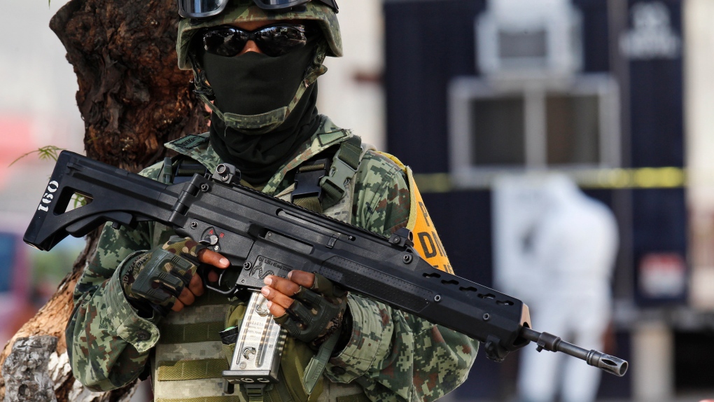A Mexican soldier stands guard near one of four police stations that was part of a simultaneous attack by unidentified men who arrived at the different police stations firing their guns, in Leon, Mexico, Wednesday, Oct. 20, 2021. (AP Photo/Mario Armas) 