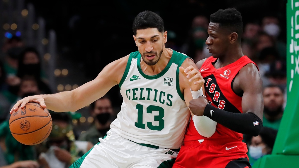 Boston Celtics' Enes Kanter (13) moves against Toronto Raptors' Isaac Bonga during the second half of an NBA basketball game, Friday, Oct. 22, 2021, in Boston. (AP Photo/Michael Dwyer) 
