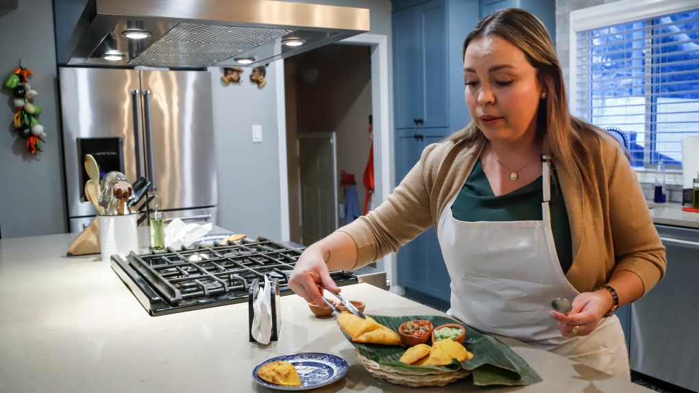 Ana Maria Moreno, who runs Valluno's Colombian Street Food and More from her home, makes empanadas in Calgary, Alta., Wednesday, Dec. 1, 2021.THE CANADIAN PRESS/Jeff McIntosh 