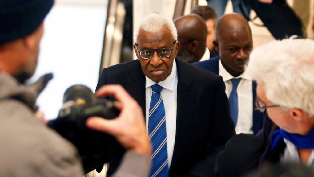 Former president of the IAAF (International Association of Athletics Federations) Lamine Diack, centre, arrives at a Paris courthouse, on Jan. 13, 2020. (Thibault Camus / AP) 