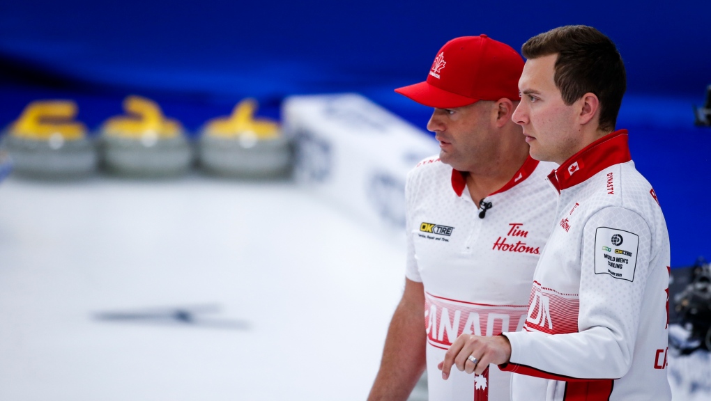 Team Canada skip Brendan Bottcher, right, and third Darren Moulding discuss strategy against Germany at the Men's World Curling Championships in Calgary on April 9, 2021. THE CANADIAN PRESS/Jeff McIntosh