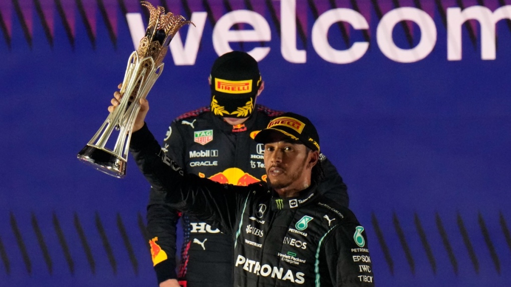 Mercedes driver Lewis Hamilton celebrates winning the Formula One Saudi Arabian Grand Prix in front of the second placed Red Bull driver Max Verstappen in Jiddah, on Dec. 5, 2021. (Hassan Ammar / AP) 