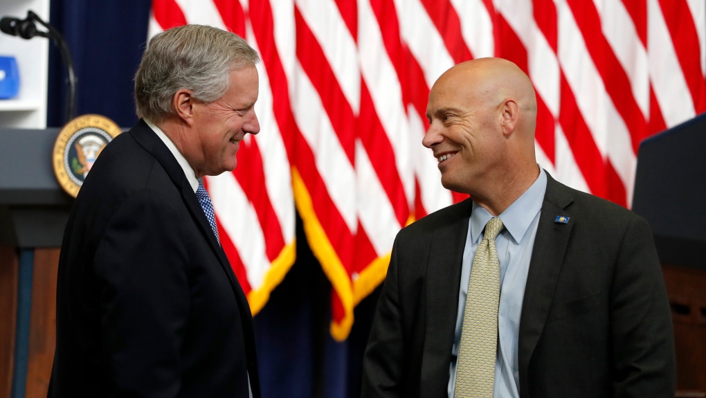 White House chief of staff Mark Meadows, left, and Vice President Mike Pence's chief of staff Marc Short talk before an event with President Donald Trump to sign executive orders on lowering drug prices in the South Court Auditorium of the White House complex, July 24, 2020, in Washington. (AP Photo/Alex Brandon)