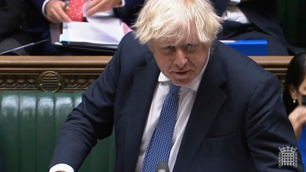 In this grab taken from video, Britain's Prime Minister Boris Johnson speaks during Prime Minister's Questions in the House of Commons, London, Wednesday, Dec. 8, 2021. Johnson says no U.K. government minister will attend the Beijing Olympics. Johnson on Wednesday called it "effectively" a diplomatic boycott. Johnson was asked in the House of Commons whether the U.K. will join the United States, Australia and Lithuania in a diplomatic boycott of the Winter Games. (House of Commons/PA via AP) 