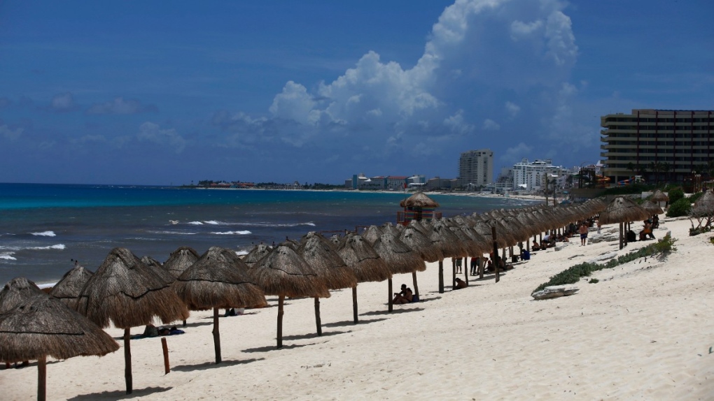 Tourists enjoy the beach before the arrival of Hurricane Grace, in Cancun, Quintana Roo State, Mexico, Aug. 18, 2021. (AP Photo/Marco Ugarte)