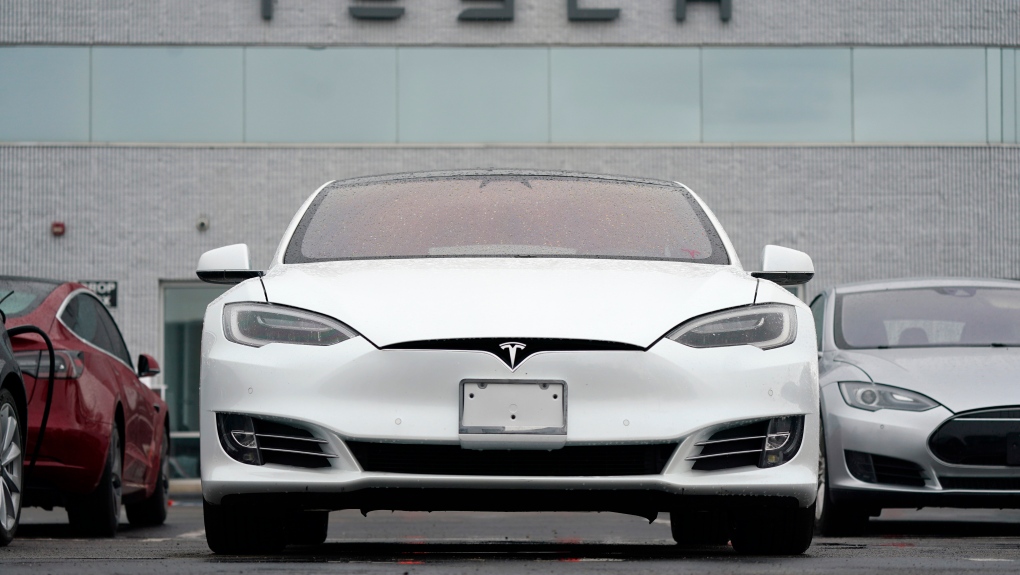 This Sunday, May 9, 2021 file photo shows vehicles at a Tesla location in Littleton, Colo. According to the U.S. National Transportation Safety Board, home security camera footage shows that the owner of a Tesla got into the driver's seat of the car shortly before a deadly crash in suburban Houston. (AP Photo/David Zalubowski)