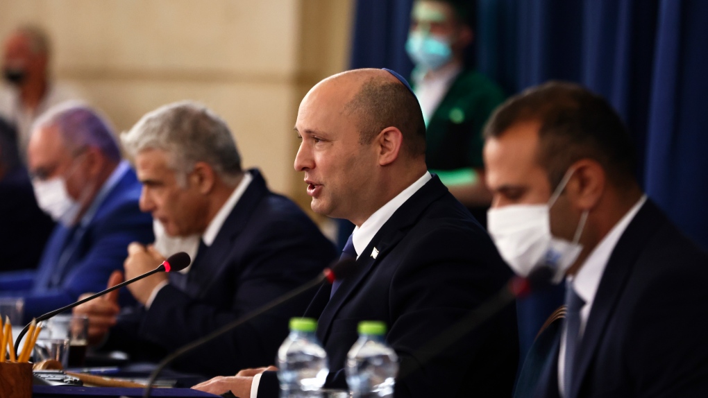Israeli Prime Minister Naftali Bennett, second right, speaks at the weekly cabinet meeting at the Foreign Ministry in Jerusalem, Sunday, Aug. 8, 2021. (Ronen Zvulun/Pool via AP) 